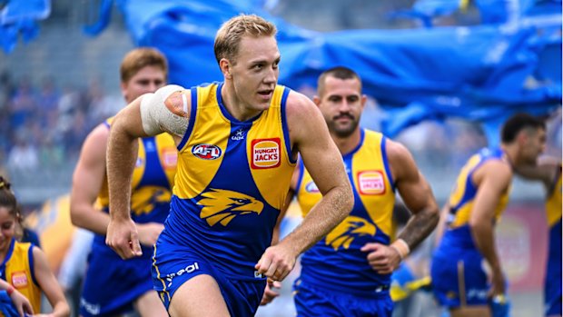 West Coast's Oscar Allen leads his team out onto the field.