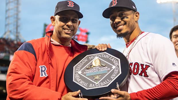Manager Alex Cora presents Mookie Betts #50 of the Boston Red Sox with the 2018 Most Valuable Player award