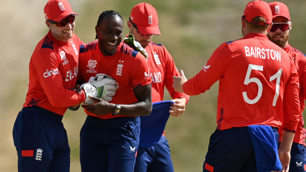England bowler Jofra Archer celebrates with teammates after taking a wicket against Oman.