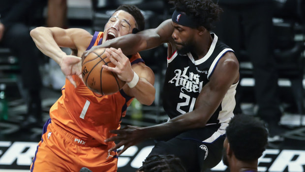  LA Clippers guard Patrick Beverley (21) blocks Phoenix Suns guard Devin Booker (1) shot during the Phoenix Suns game versus the Los Angeles Clippers game 3 NBA Western Conference Finals game on June 24, 2021, at Staples Center in Los Angeles, CA