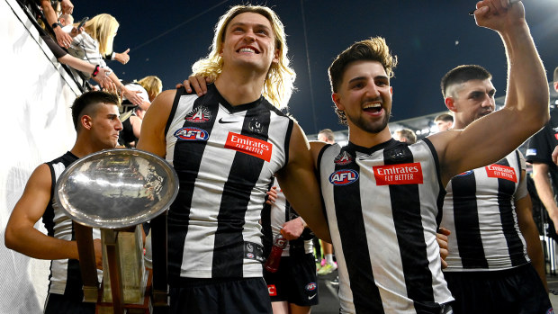Darcy Moore and Josh Daicos of the Magpies celebrate winning the Anzac Day match against Essendon.