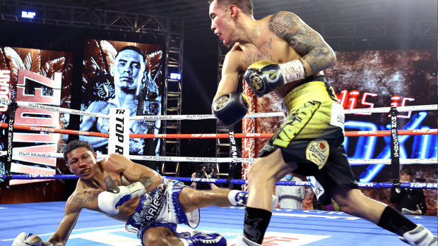 Oscar Valdez knocks-down Miguel Berchelt during their fight for the WBC super featherweight title at the MGM Grand Conference Center on February 20, 2021 