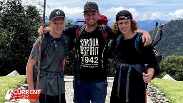 Former footy player Mark Hughes (middle) with his family taking on the Kokoda trail. 