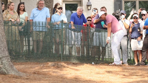 Cameron Smith hits a shot from under the trees on No. 18