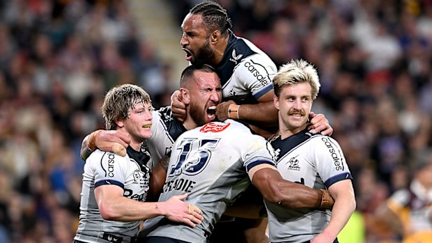 Melbourne Storm players celebrate a try against the Brisbane Broncos, Cameron Munster, Harry Grant, Justin Olam