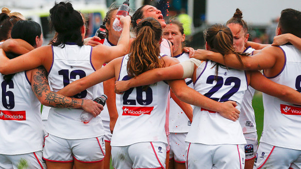 Fremantle players sing the team song after winning the round six AFLW match