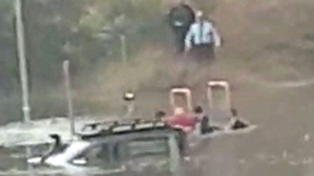 NSW Police rescue man from ute stuck in floodwaters.