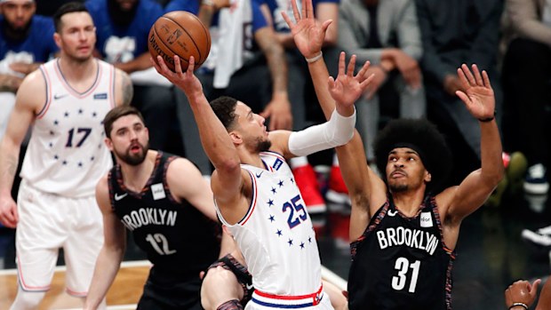 Harris watches as Simmons dunks during the NBA playoffs last season