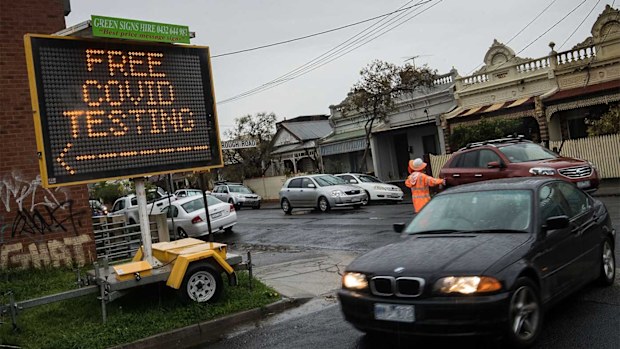 Cars enter a drive through COVID testing site in Brunswick in Melbourne.