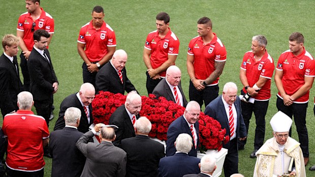 John Raper's coffin is carried from the SCG as St George Illawarra players form a guard of honour.