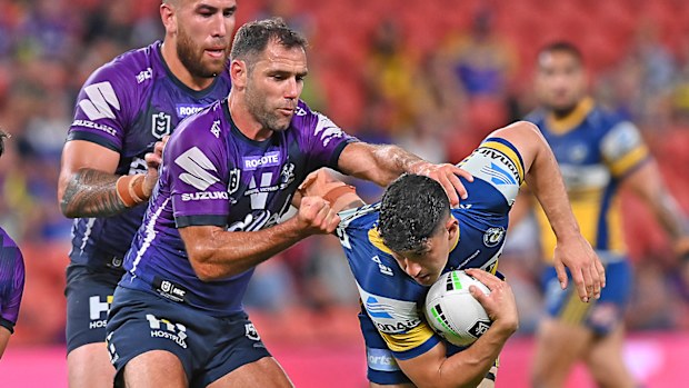 Dylan Brown of the Eels is tackled by Cameron Smith of the Storm 