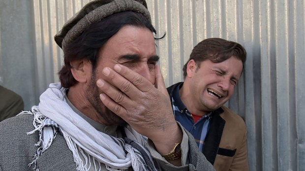 Afghans cry after an attack on a military hospital in Kabul, Afghanistan. (AFP)