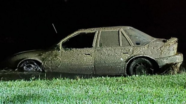 A neighbour photographed this car being pulled from a retention pond.