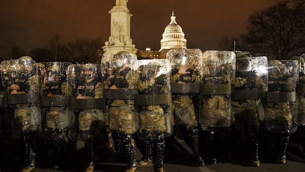 DC National Guard stand outside the Capitol.