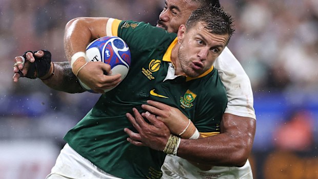 Handre Pollard of South Africa is held by Manu Tuilagi during the Rugby World Cup France 2023 semi final match between England and South Africa.