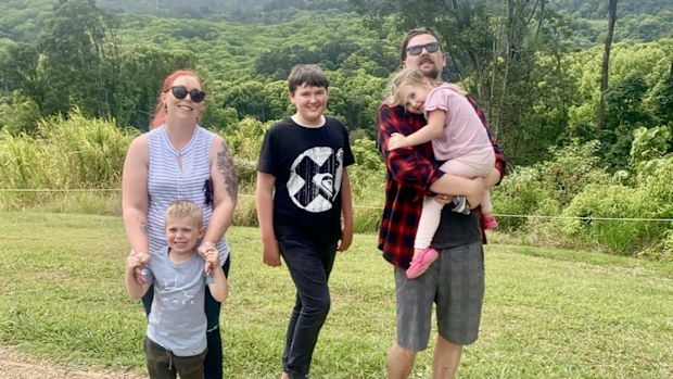 Ashlee Law stands with her partner and three children for a photo at a nature lookout.