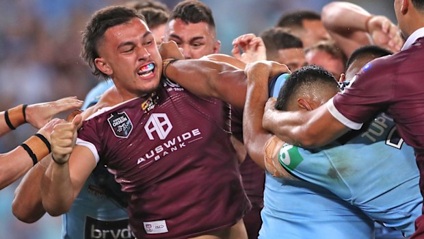 Tino Fa'asuamaleaui of the Maroons and Payne Haas of the Blues scuffle 