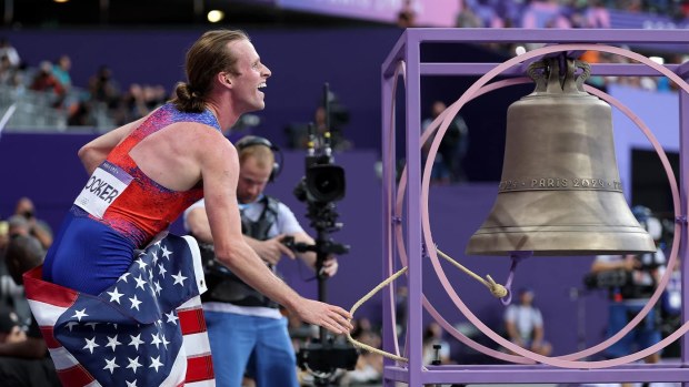 Cole Hocker dings the giant bell at the Stade de France.