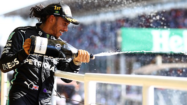 Race winner Lewis Hamilton of Great Britain and Mercedes GP celebrates on the podium 