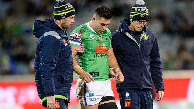 Nick Cotric of the Raiders is helped from the field 