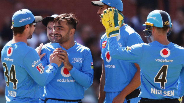 Rashid Khan of the Strikers celebrates with team mates after taking the wicket of Josh Lalor of the Heat during the Big Bash League match 