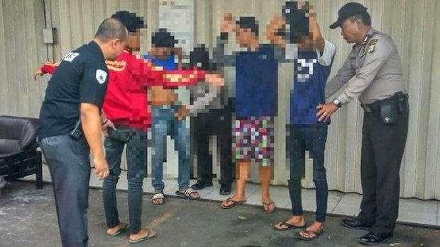 Jakarta police officers search suspected petty criminals. (Facebook).