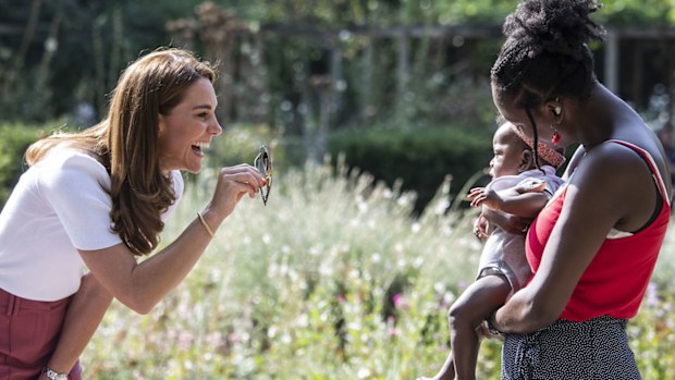 Kate Middleton, Duchess of Cambridge meets with MUSH mother and baby group member, Morgan Alex Cassius and her 6 month old, Makena Grace during a visit to Battersea Park, London, Tuesday, Sept. 22, 2020