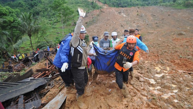 Rescuers carry the body of a landslide victim in West Java.