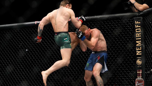 Conor McGregor lands a knee to the face of Donald Cerrone in the first round in a welterweight bout