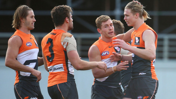 Cam McCarthy (right) is congratulated by GWS teammates after slotting a goal against St Kilda in 2015.