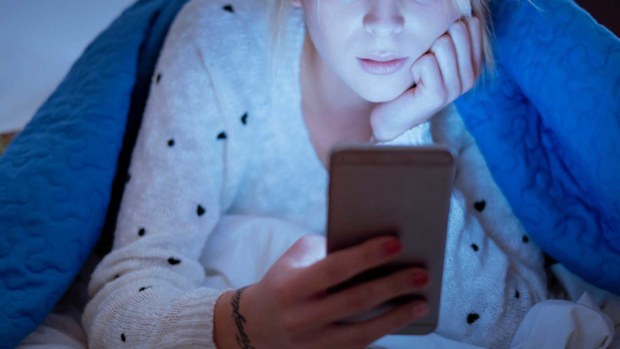 Woman on phone in bed