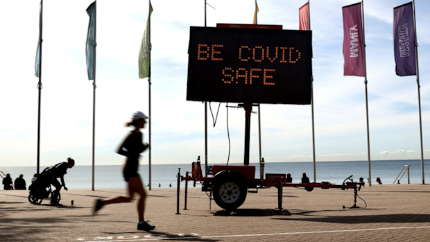 A Covid-19 public message sign at Manly Beach in Sydney, Australia, on Monday, Aug. 30, 2021. 