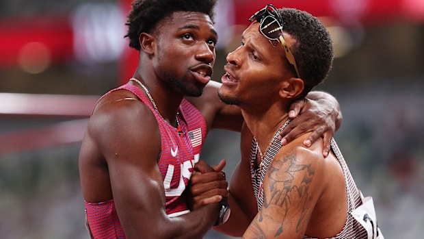 Gold medallist Andre de Grasse of Team Canada shakes hands with bronze medallist Noah Lyles after the men's 200 metres at the Tokyo Olympics.
