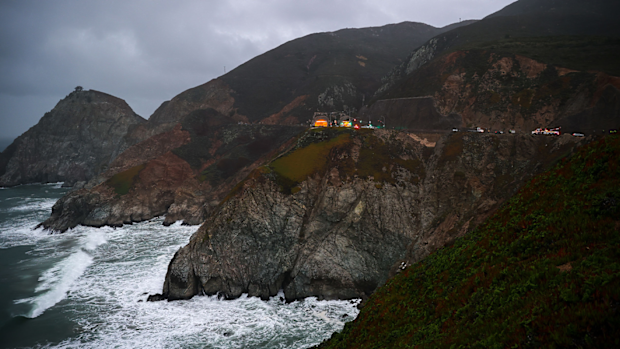 Rescue teams are pictured here at the Pacific Coast Highway location where a Tesla plunged over a cliff on January 2.