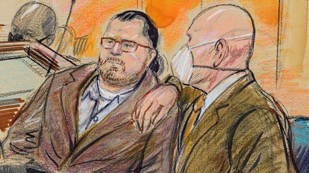 US Capitol rioter Guy Reffitt and his lawyer sit in a courtroom