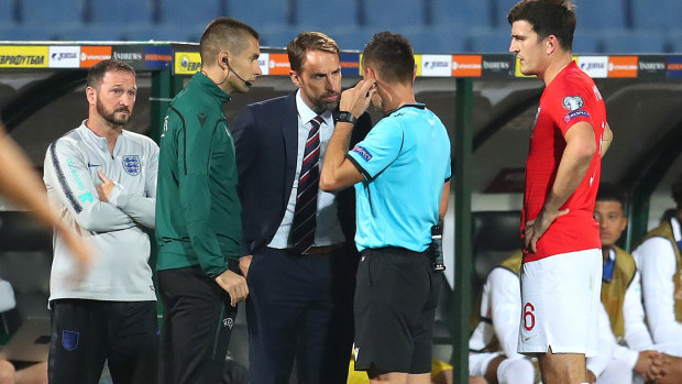 England officials and coaches speak to referees