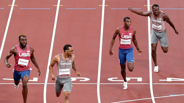 Andre de Grasse of Team Canada finishes ahead of Kenneth Bednarek and Noah Lyles of Team United States to win the gold medal in the Men's 200m Final on day twelve of the Tokyo Olympic Games.