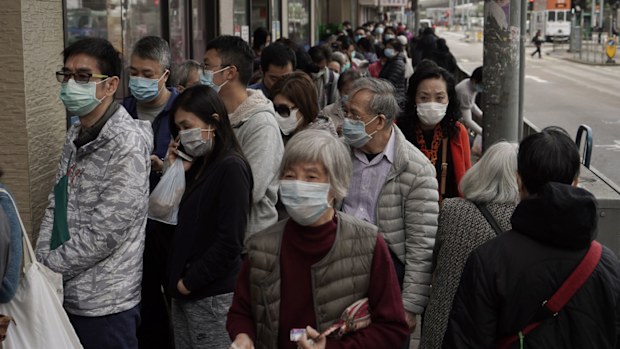 People queue up to buy face masks in Hong Kong, Friday, Feb. 7, 2020