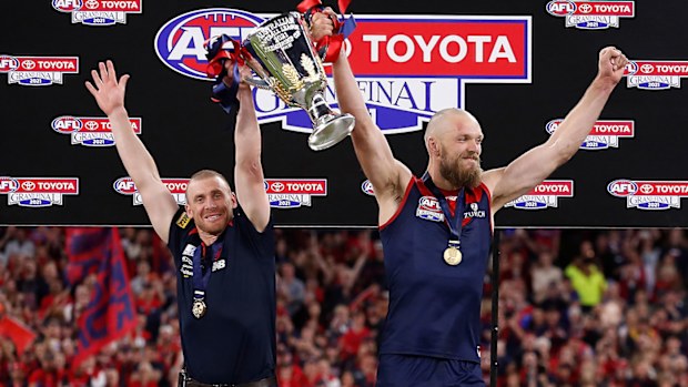 Simon Goodwin, Senior Coach of the Demons and Max Gawn of the Demons hold the cup aloft during the 2021 Toyota AFL Grand Final match between the Melbourne Demons and the Western Bulldogs at Optus Stadium on September 25, 2021 in Perth, Australia. (Photo by Michael Willson/AFL Photos via Getty Images)