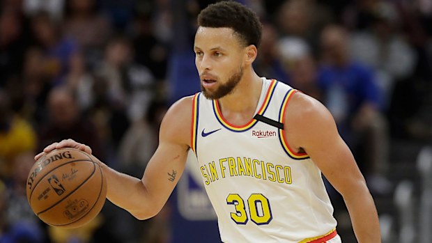 Golden State Warriors guard Stephen Curry (30) dribbles the ball up the court 
