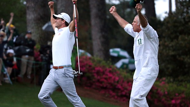 Adam Scott and Steve Williams celebrate after the winning putt drops at the 2013 Masters.