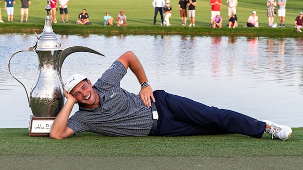 Bryson Dechambeau poses with the winning trophy at the Dubai Desert Classic 