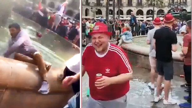 Liverpool fans laugh at pushing locals and tourists into a Barcelona fountain