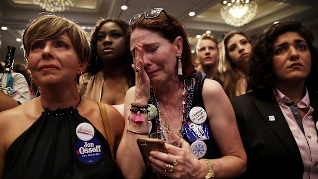 Dejected Jon Ossoff supporters weep as his defeat sets in. (AAP)