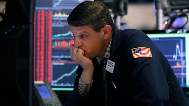 Trader Michael Gallucci works at his post on the floor of the New York Stock Exchange today. Trading was halted as stocks plummeted on the back of coronavirus concerns.