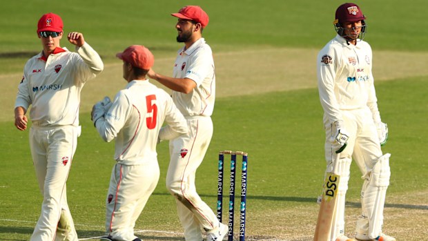 Usman Khawaja of Queensland leaves the field after being dismissed during day three of the Sheffield Shield 