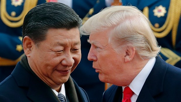 US President Donald Trump chats with Chinese President Xi Jinping during a welcome ceremony at the Great Hall of the People in Beijing. The United States and China are scheduled to resume talks today to try to back off an escalating trade war. 