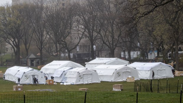 A Samaritan's Purse crew works on building a 68 bed emergency field hospital specially equipped with a respiratory unit in New York's Central Park.