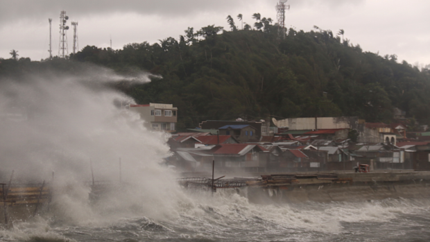 A strong typhoon slammed into the eastern Philippines on Thursday after authorities evacuated tens of thousands of people while trying to avoid the virus risks of overcrowding emergency shelters. (AP Photo/Simvale Sayat)