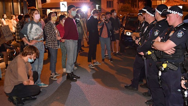 Police and protestors are seen outside the Kangaroo Point Central Hotel in Brisbane, Friday, June 12, 2020.